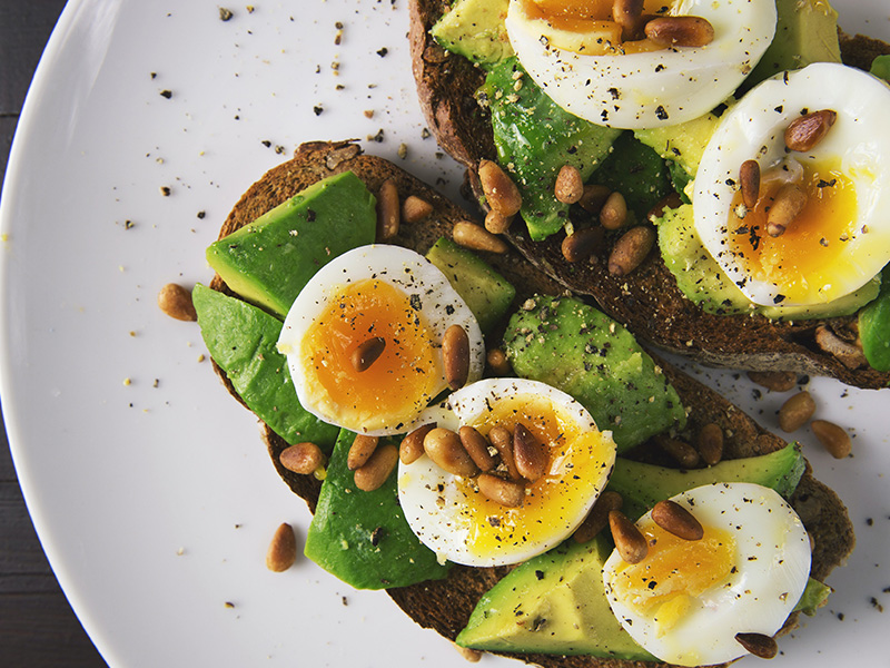 Eggs, avocado, and nuts on toast