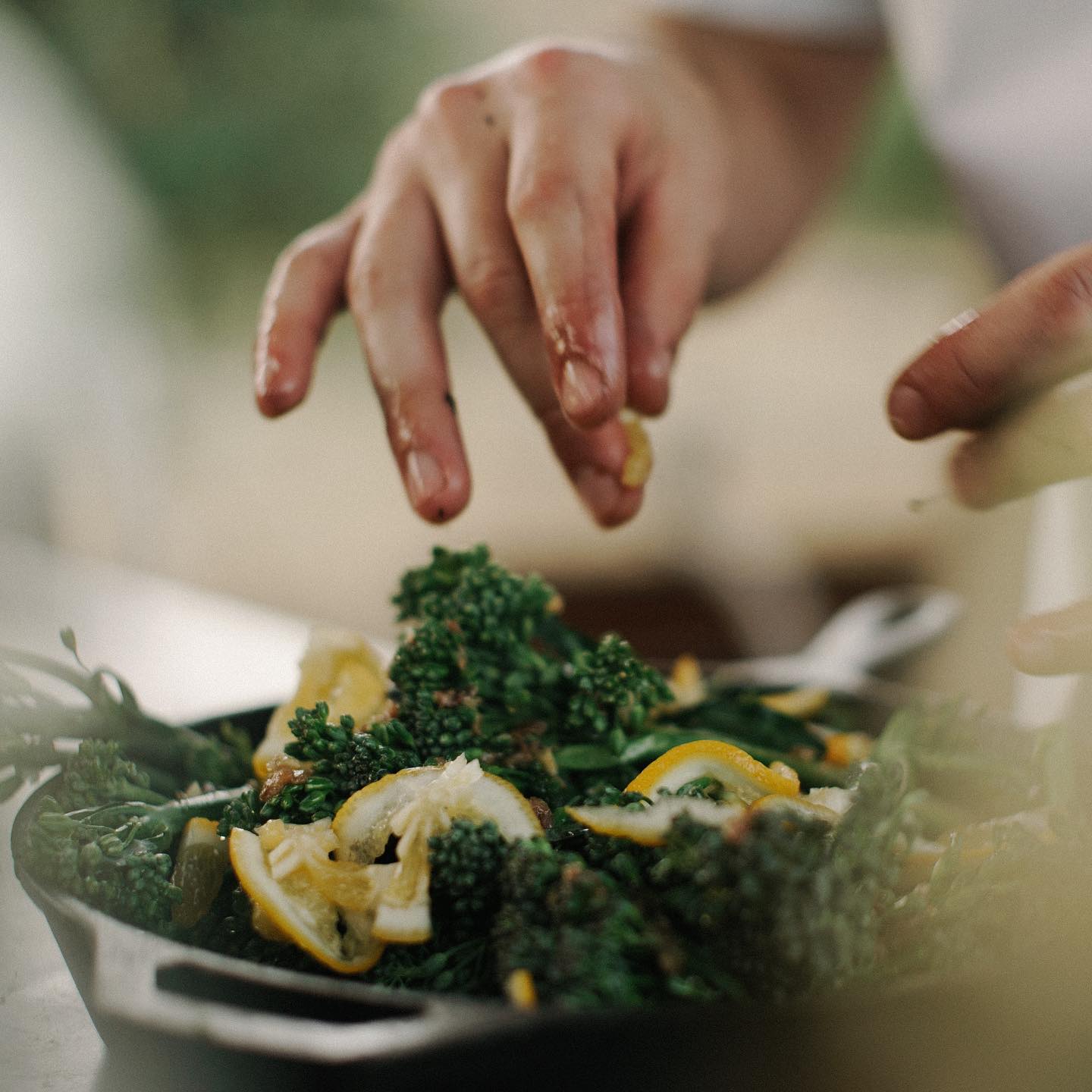A chef cooking with fresh vegetables