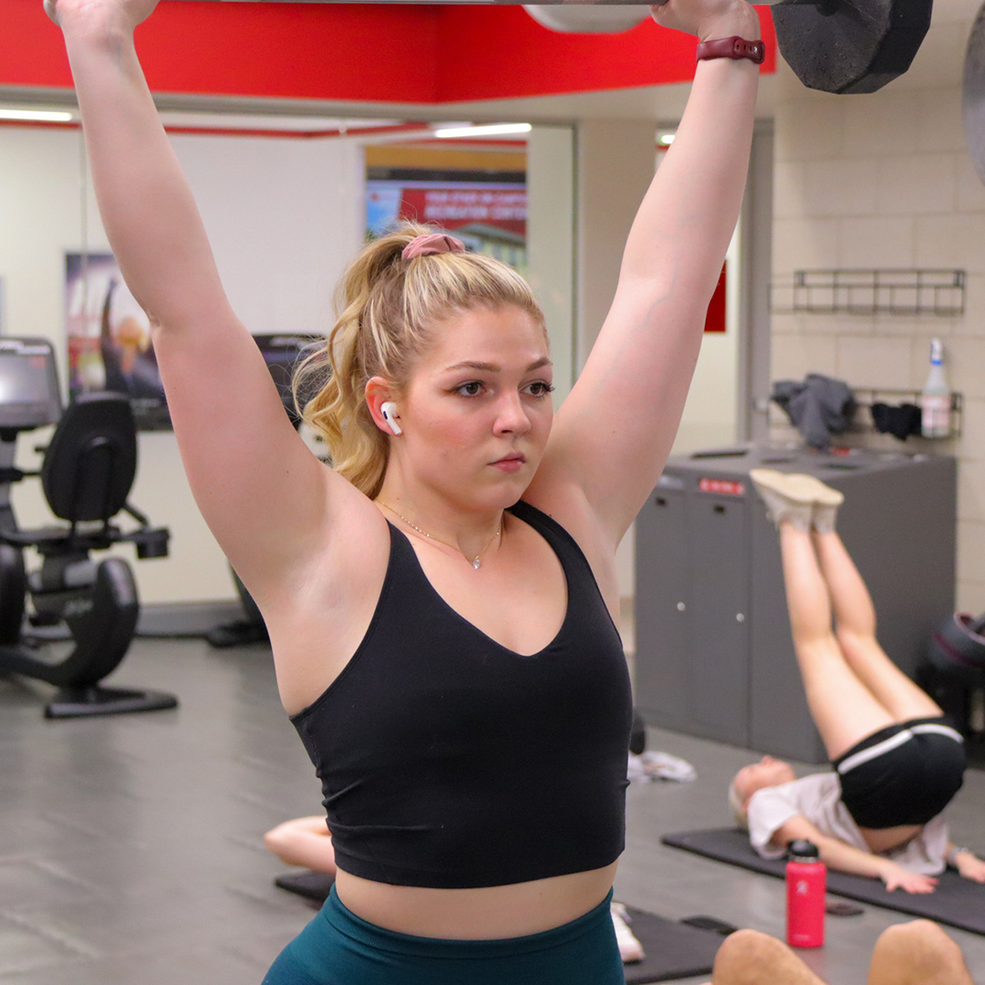Student performs a lift in the Campus Recreation Strength Training and Conditioning Room.