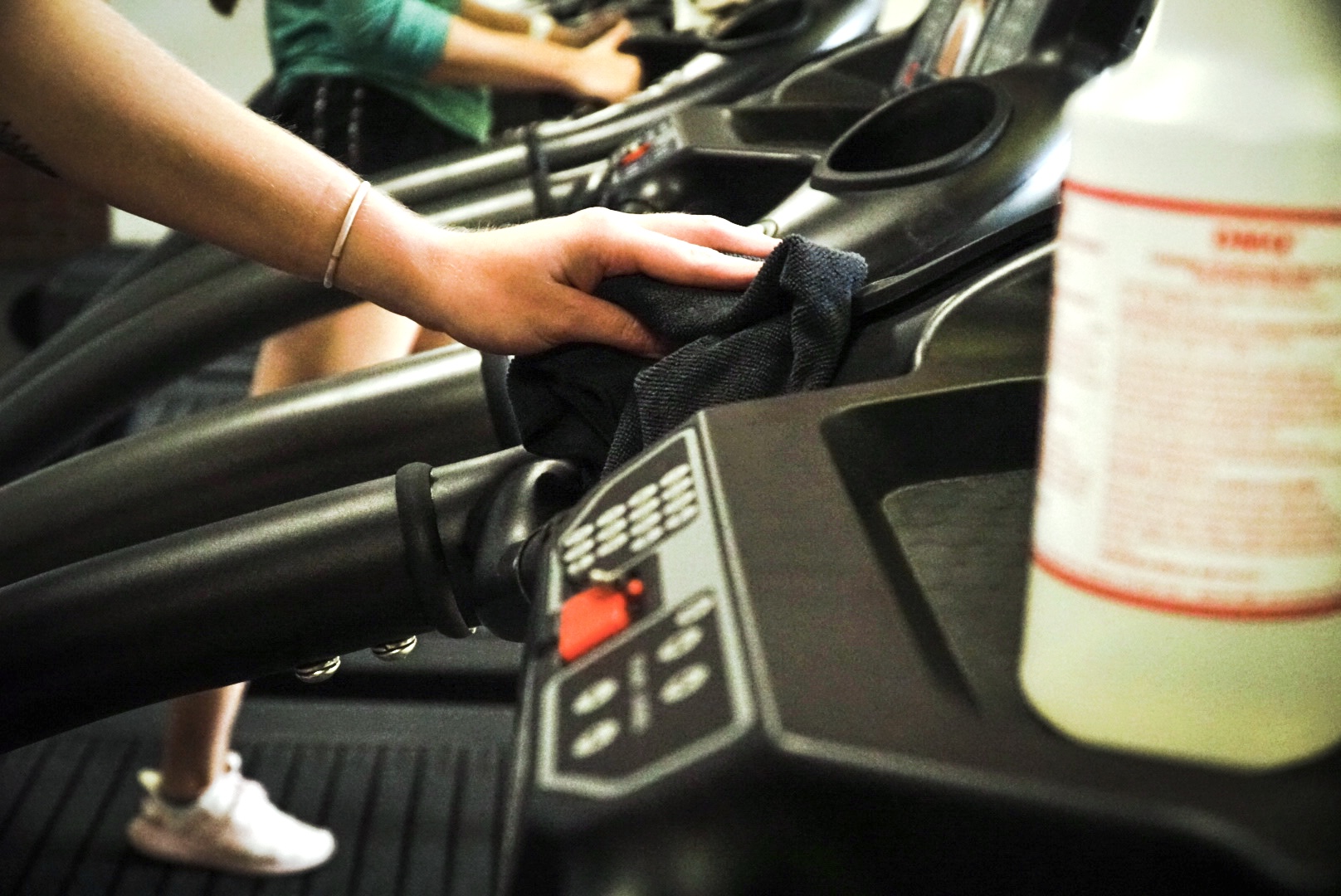 Patrons clean treadmills in the recreation center