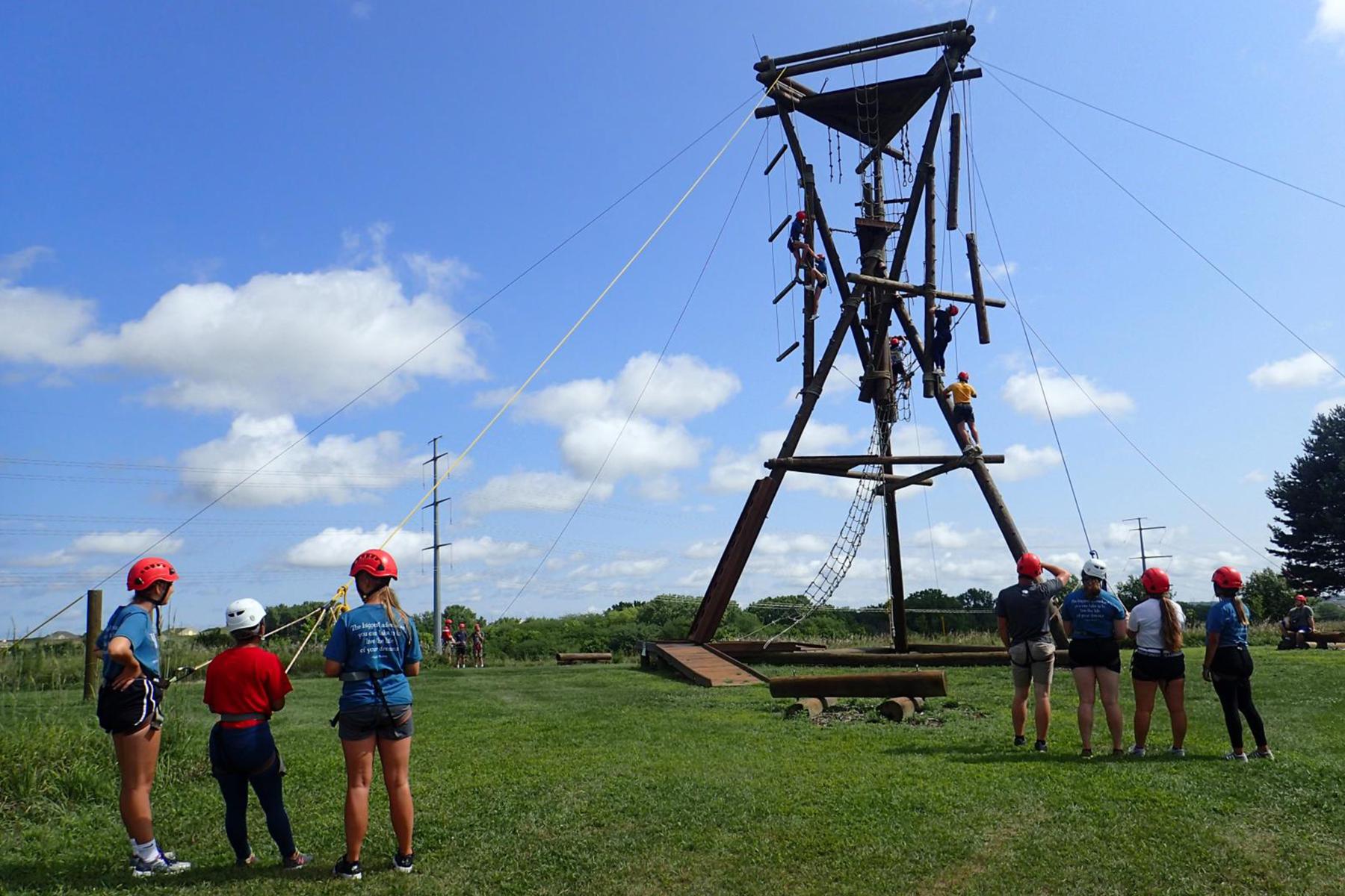 Individuals participate on the challenge course at the Leadership Training Center.