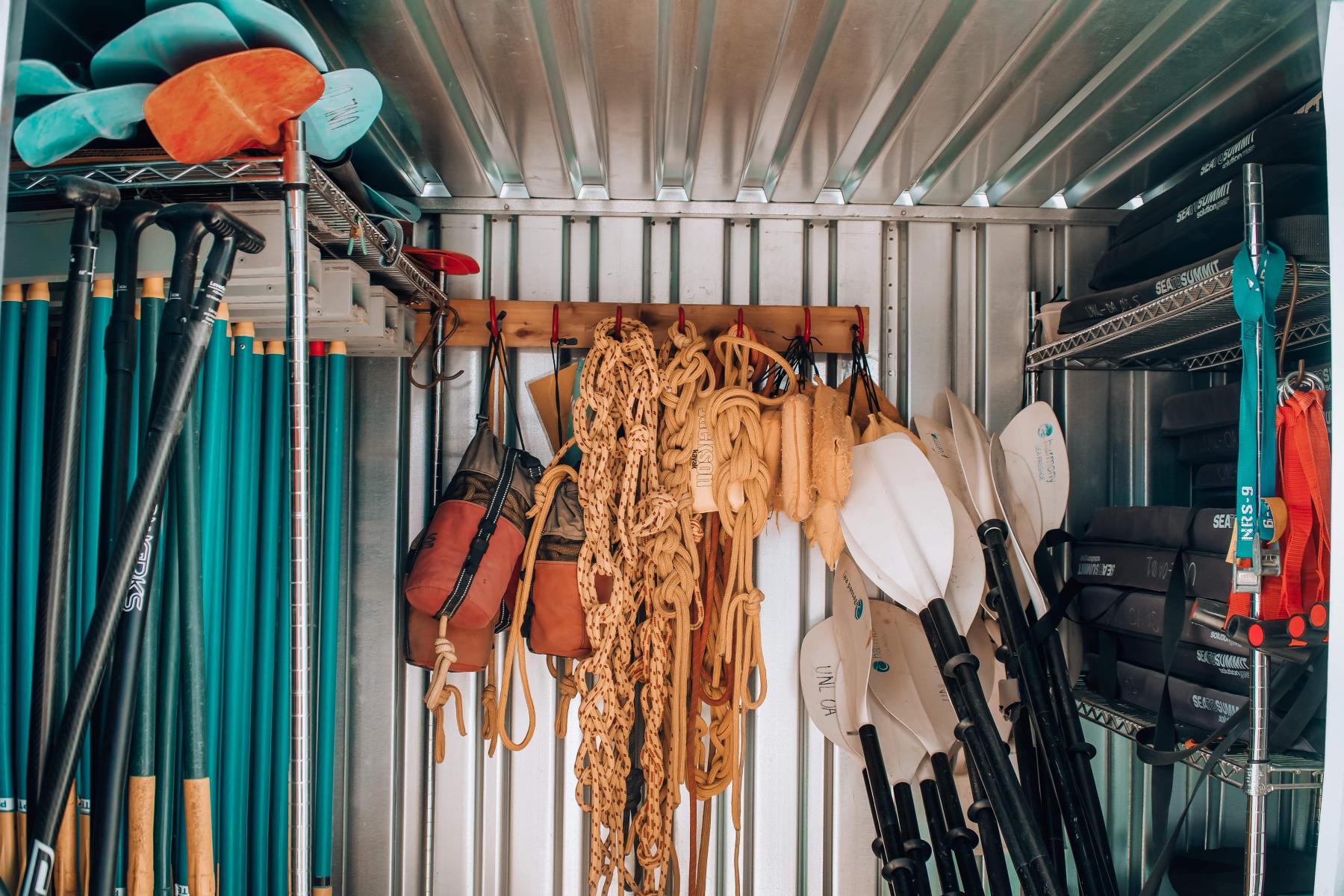 Climbing and paddling equipment stored in a container