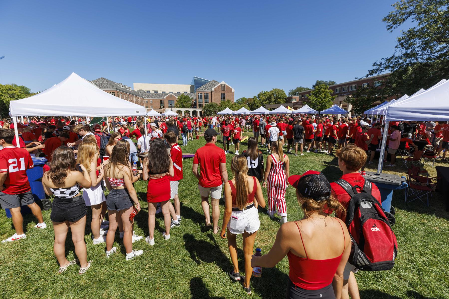 Students attend the Husker Tailgate in the green space of the Nebraska Union