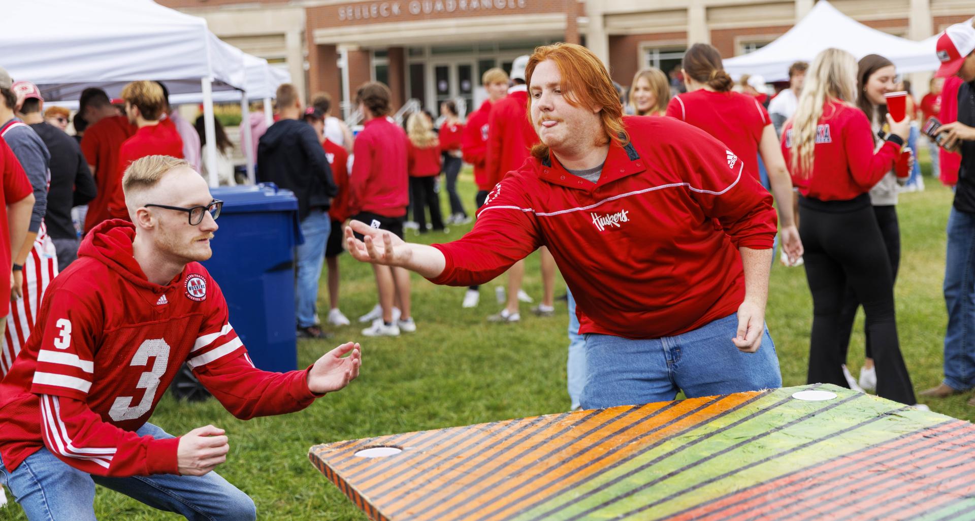 Students play games during a Husker Tailgate in the green space of the Nebraska Union
