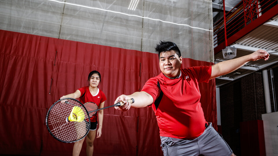 two people playing badminton