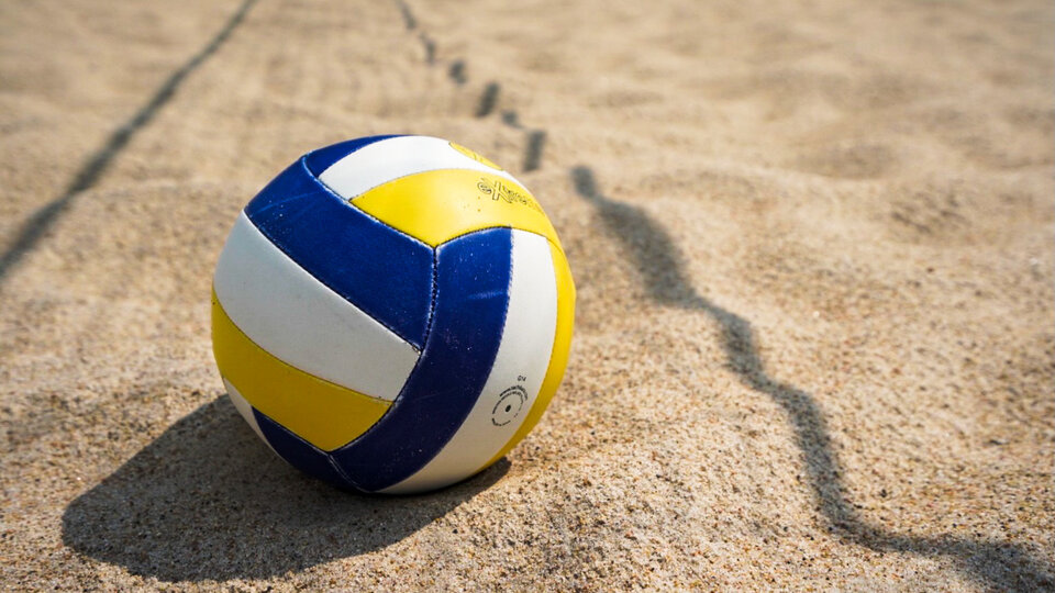 volleyball laying on the sand.