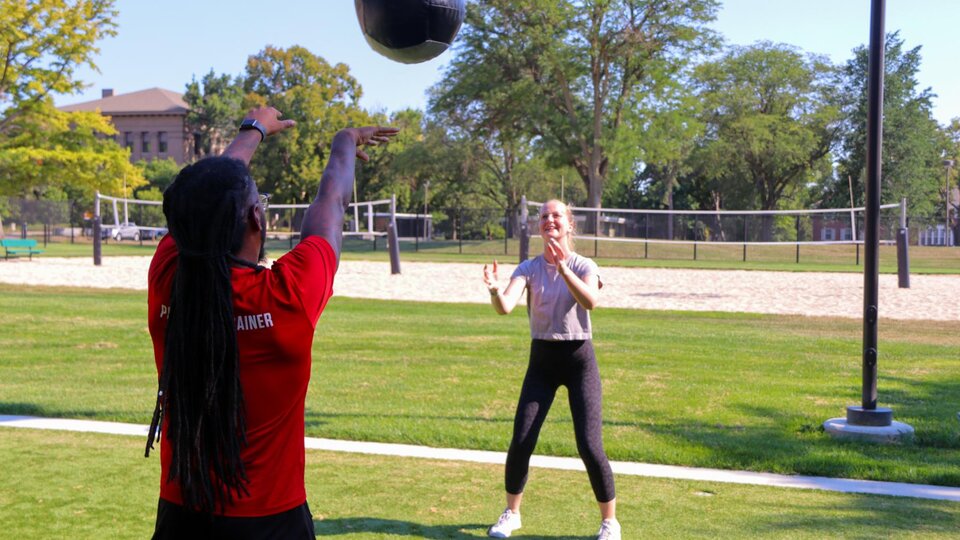 A personal trainer working with a client