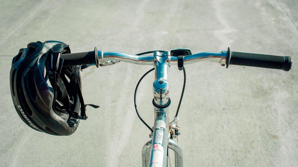 Looking at the road over a bike's handlebars.