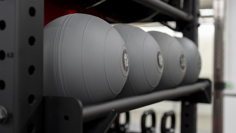medicine balls on rack.