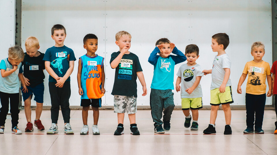 Group of children standing in a line playfully