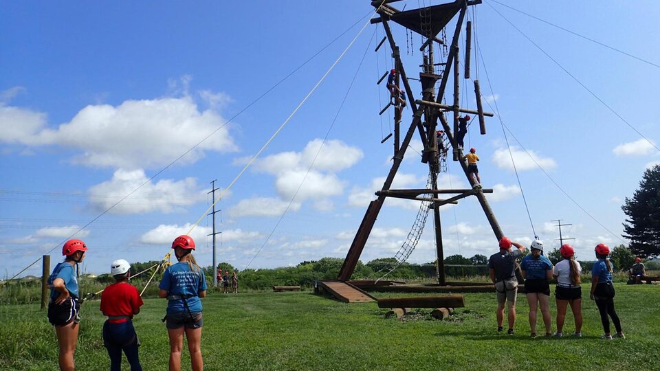 Individuals participate on the challenge course at the Leadership Training Center.