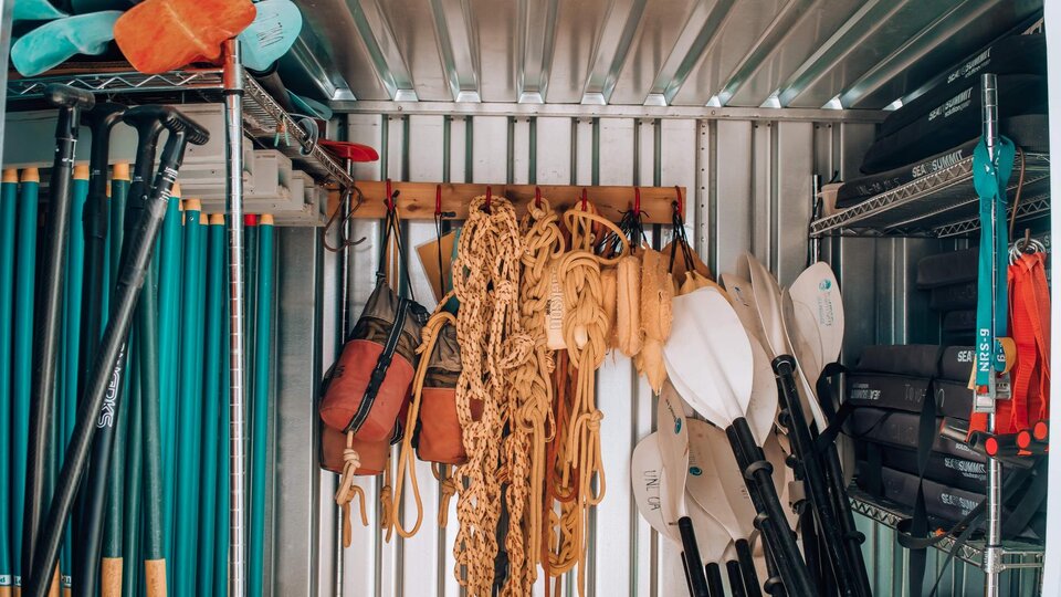Climbing and paddling equipment stored in a container
