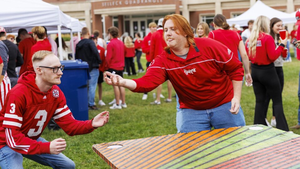 Students play games during a Husker Tailgate in the green space of the Nebraska Union