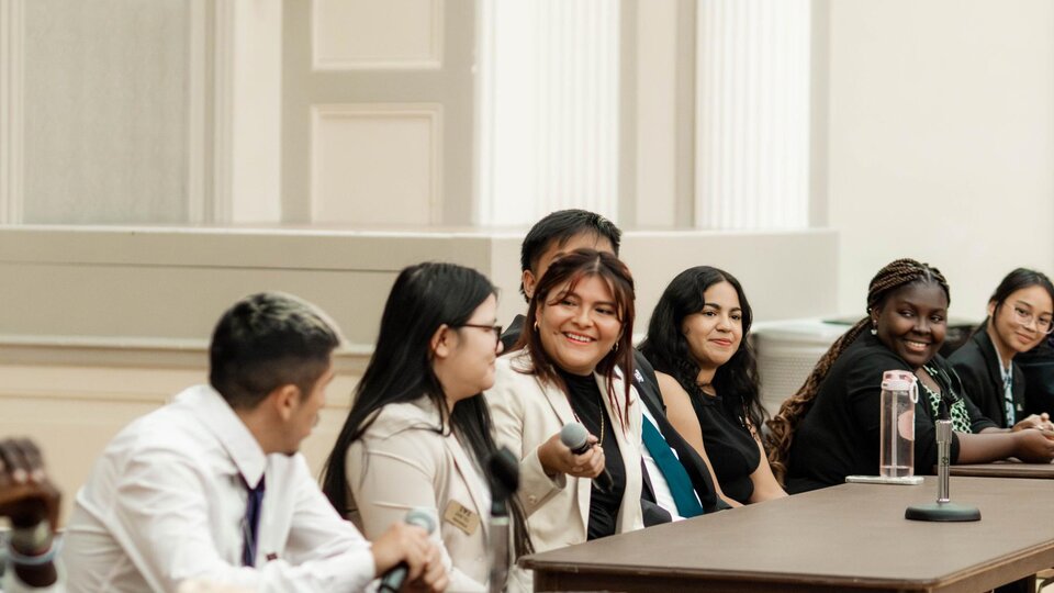 Students speak during a forum for comment