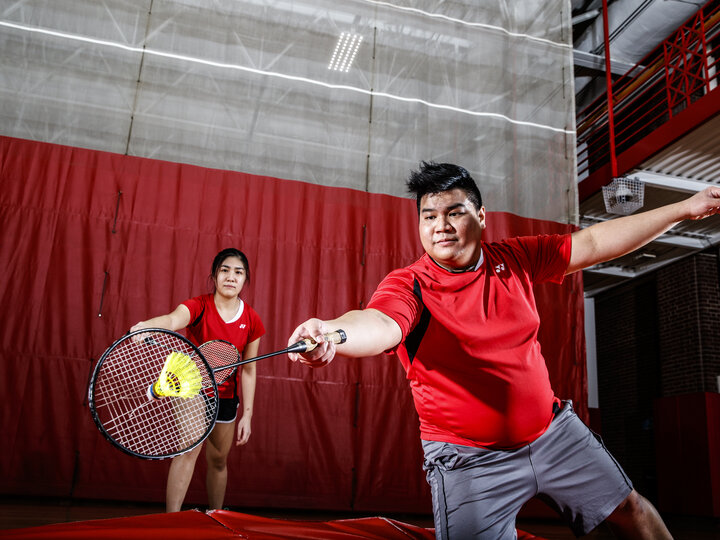 two people playing badminton