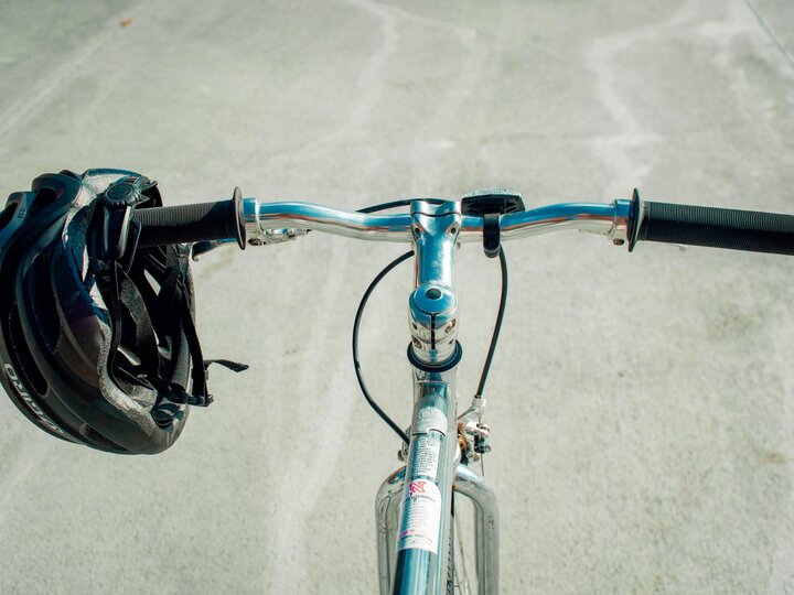 Looking at the road over a bike's handlebars.
