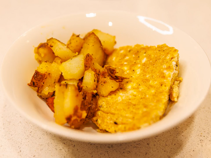 Breakfast for Dinner Egg Casserole and Country Potatoes in a white bowl