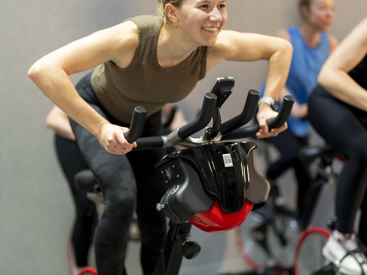 person smiling on a cycle bike