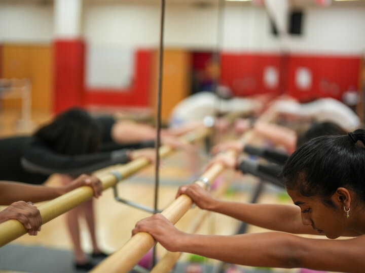 people stretching against a mirror