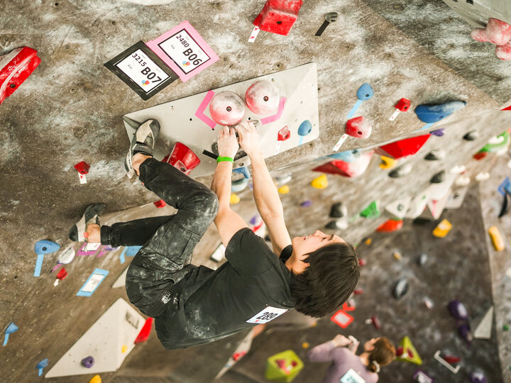 Person climbing on indoor rock wall.