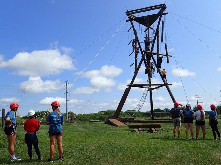 Individuals participate on the challenge course at the Leadership Training Center.