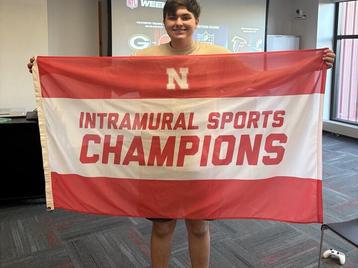 Student standing with flag.