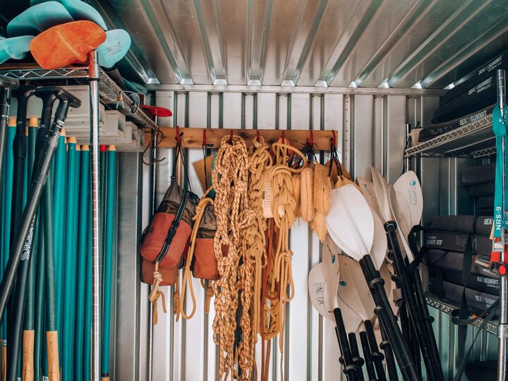 Climbing and paddling equipment stored in a container
