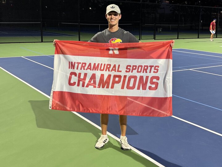 Student standing with flag.