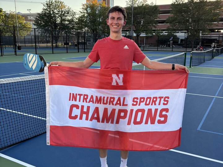 Student standing with flag.