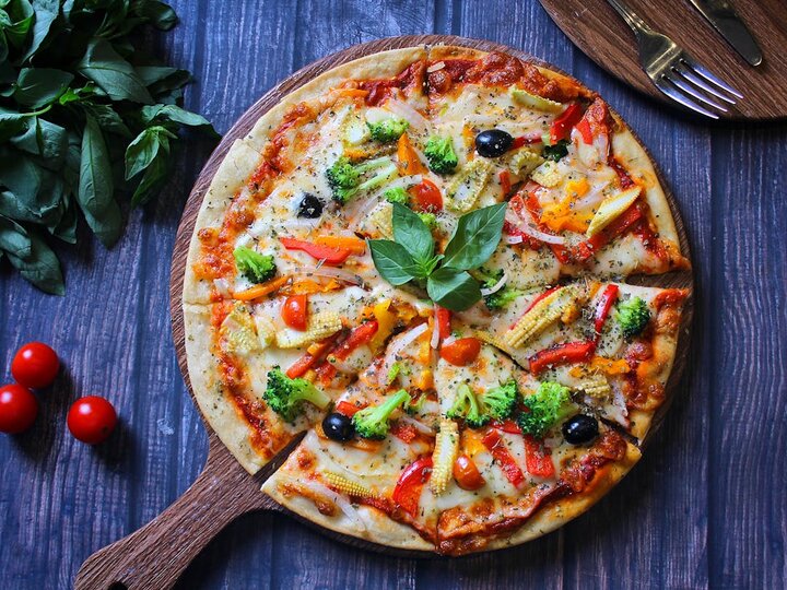 pizza on a wooden pizza paddle