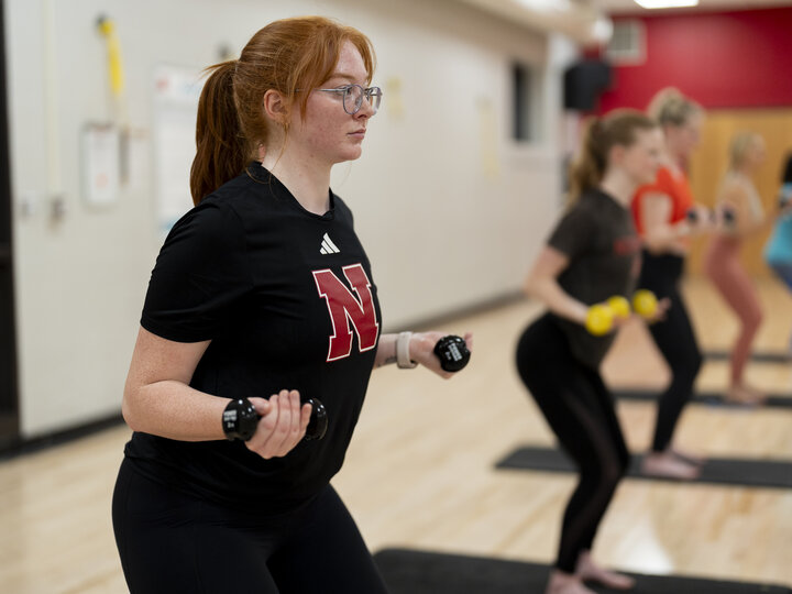 person doing strength exercise with dumbells