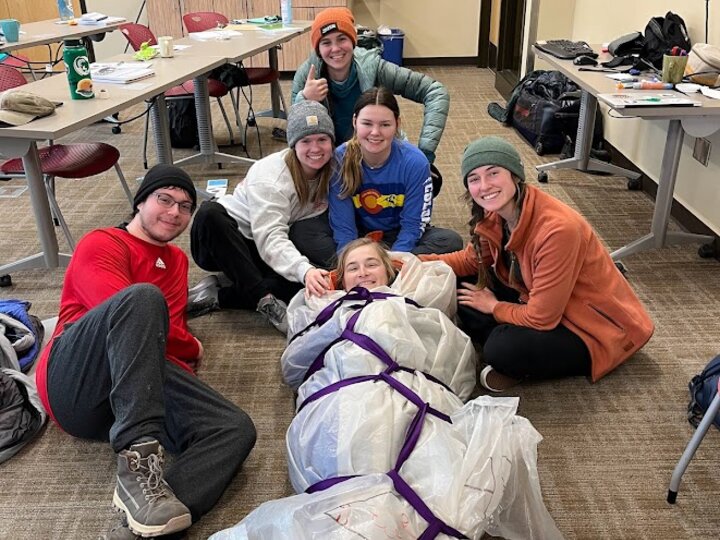 Group making a hypothermia wrap