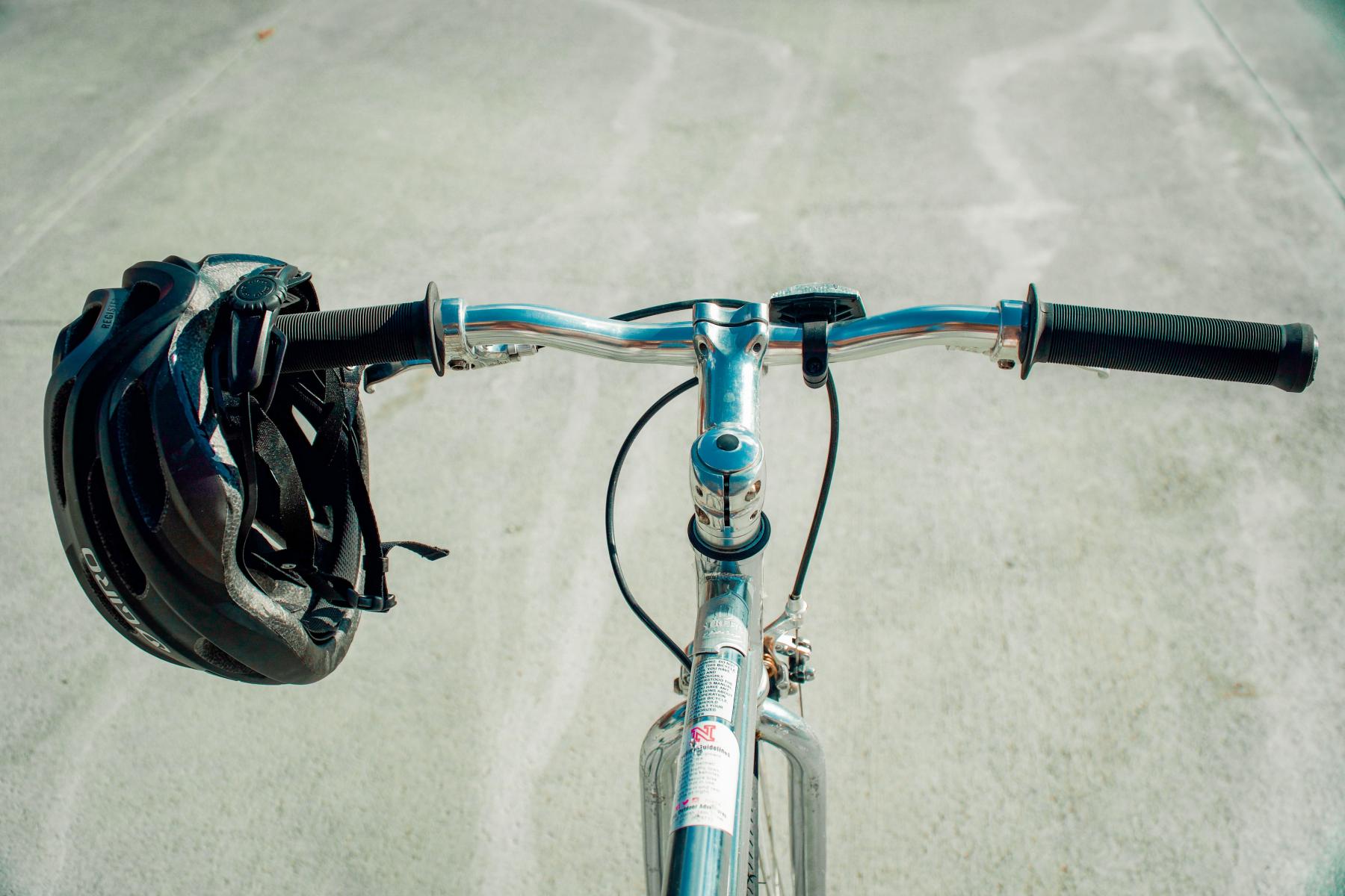 Looking at the road over a bike's handlebars.