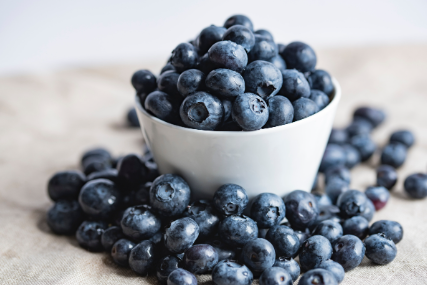 Bowl of blueberries on a tablecloth.