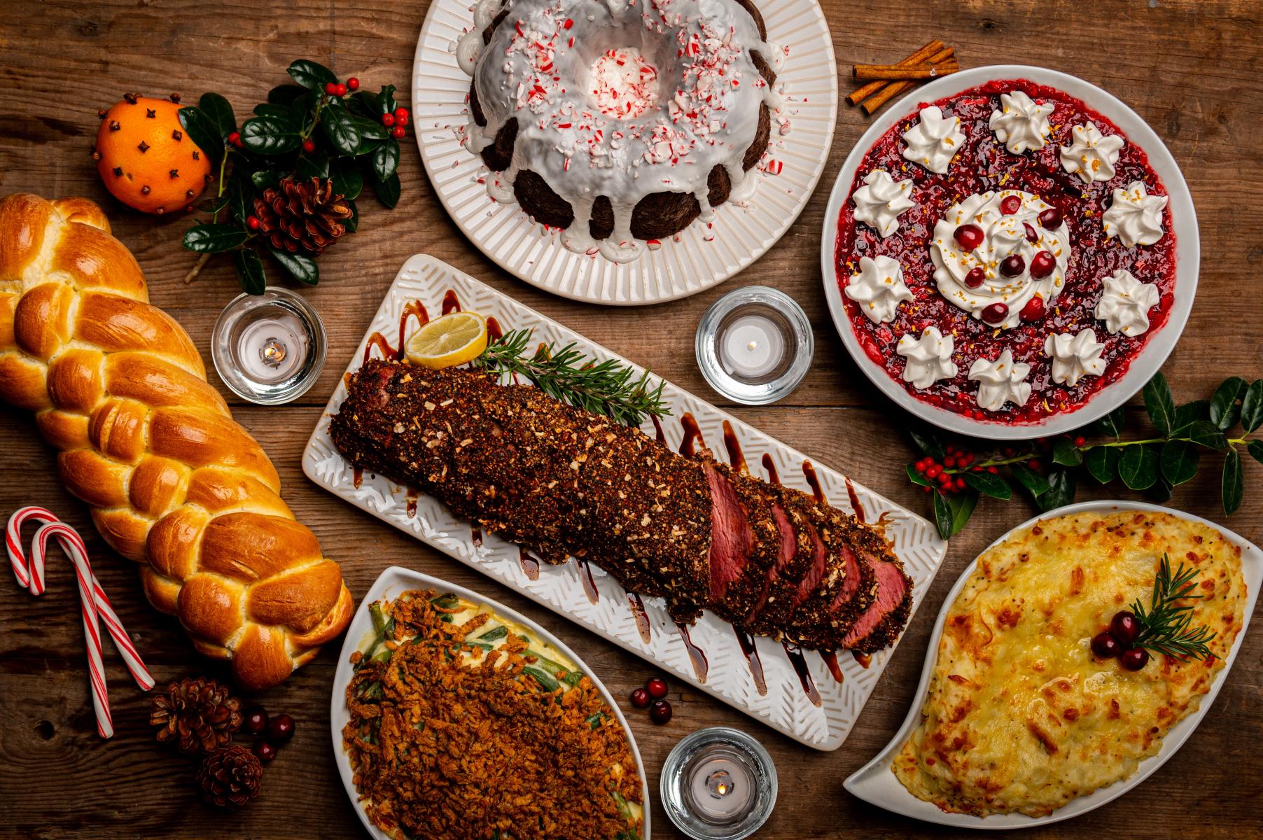 Holiday meal items sit on a wood table