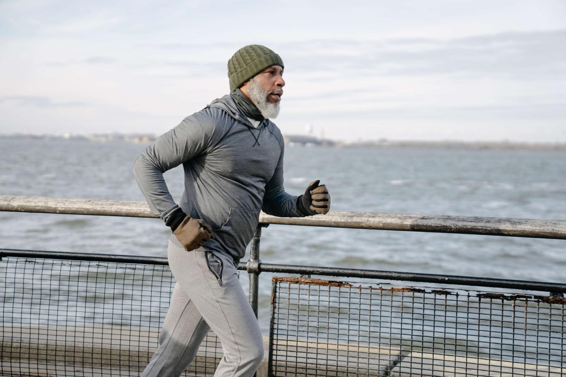 Senior citizen runs along a body of water