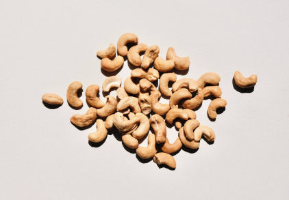 A pile of cashews on a white background.