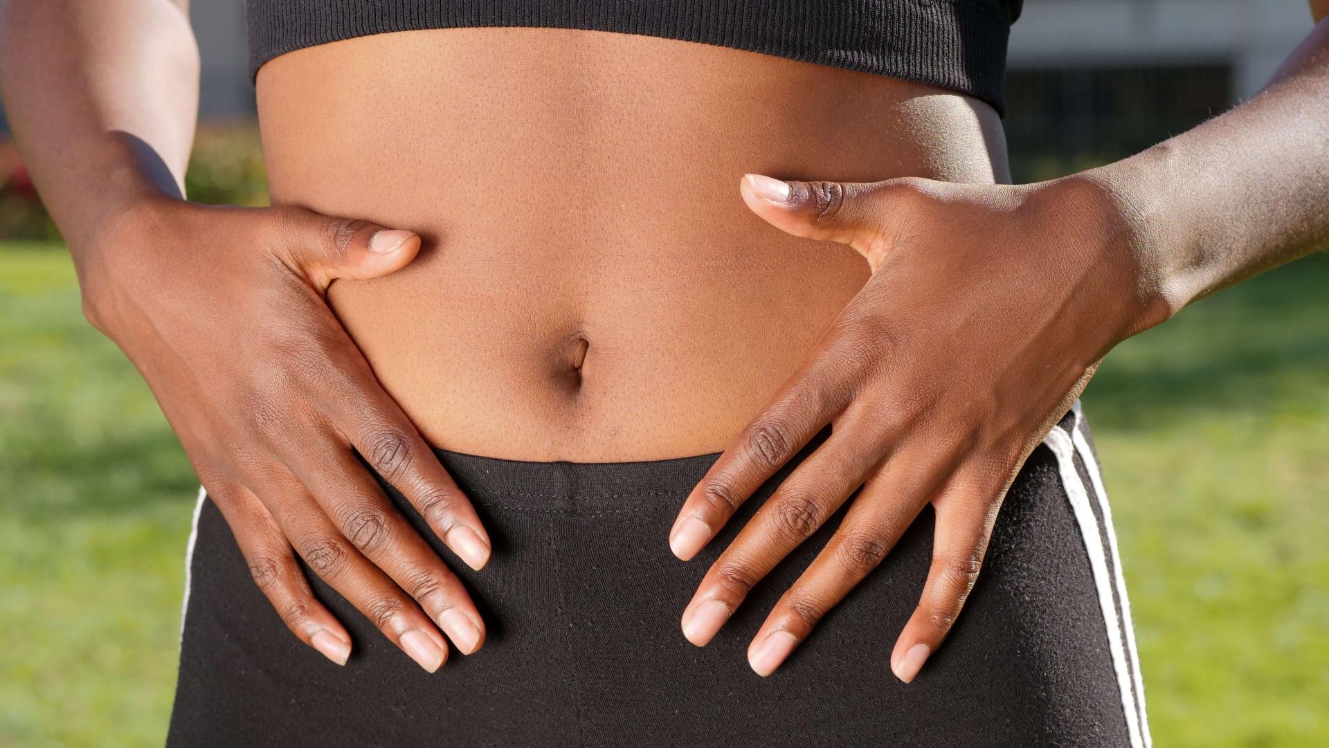 Person with their hands on their stomach