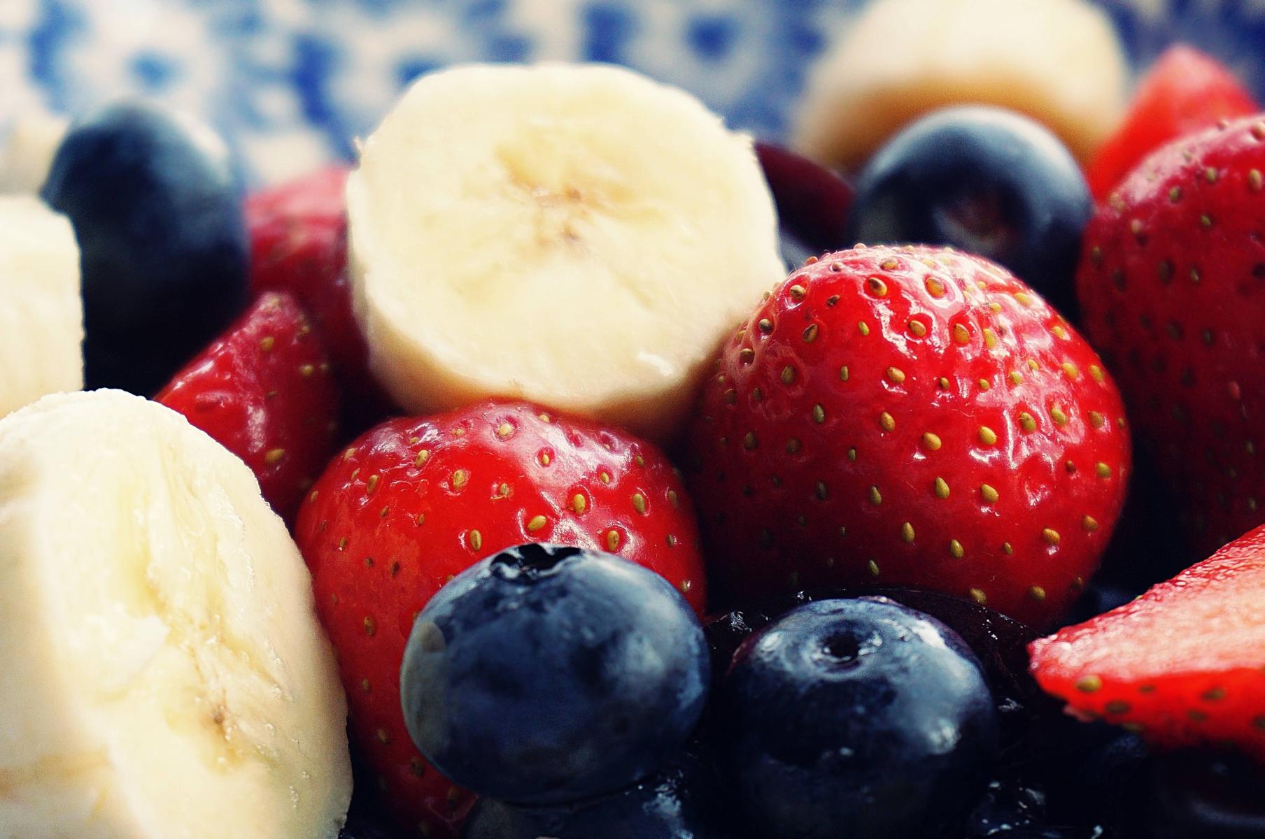 Banana slices, strawberries, and blueberries